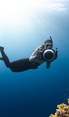 a person swimming in the ocean with a mask on