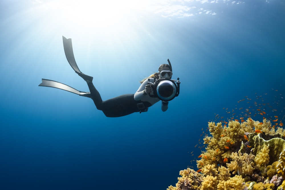 a person swimming in the ocean with a mask on