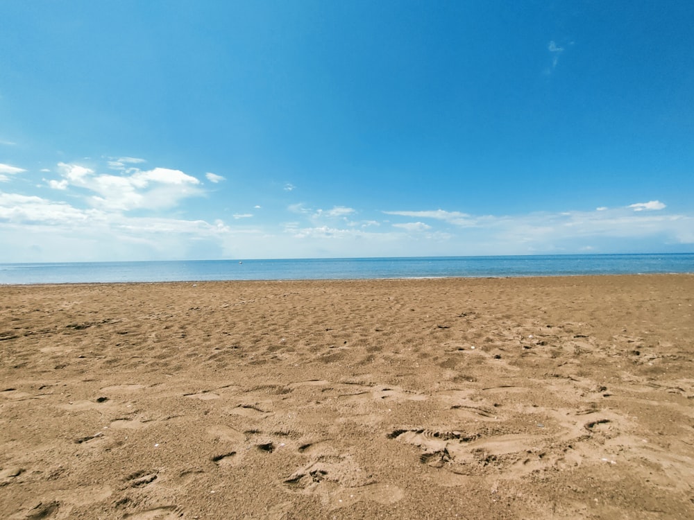 a sandy beach with footprints in the sand