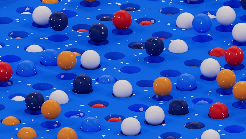 a group of balloons floating on top of a blue surface