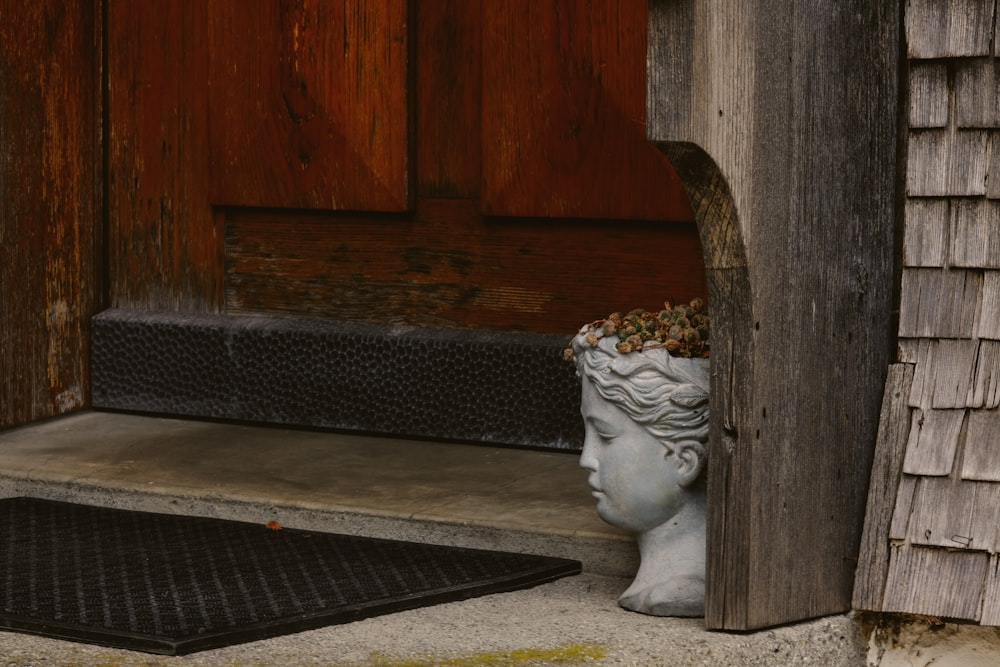 a statue of a woman's head sticking out of a door