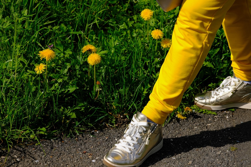 a person in yellow pants and white sneakers