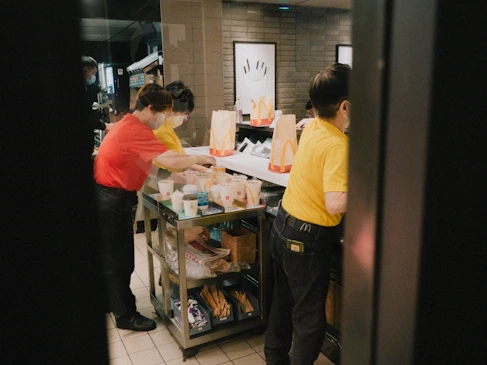 a couple of people that are standing in a kitchen