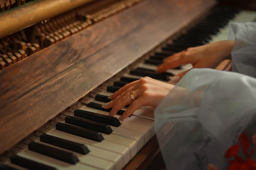 Close-up of hands gently playing wooden percussion instruments in warm lighting