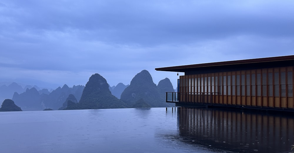 a wooden building sitting on top of a body of water