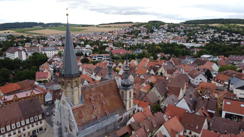 an aerial view of a city with a church steeple