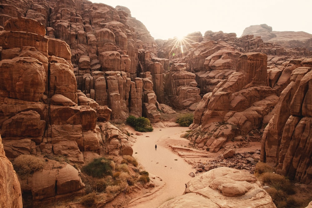 a person walking through a canyon in the desert