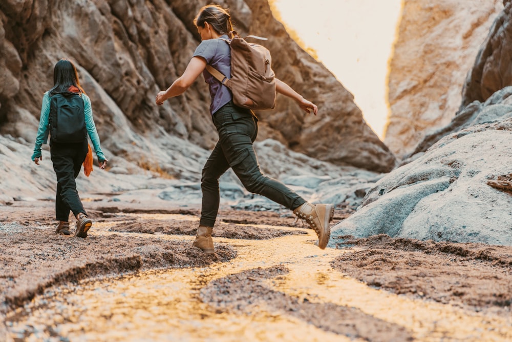 a couple of people that are walking in the dirt