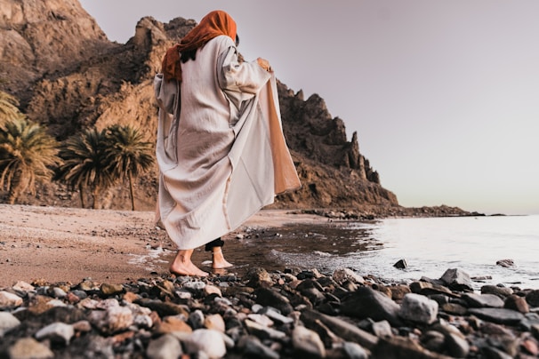 A tranquil scene featuring modest attire against a sandy backdrop.