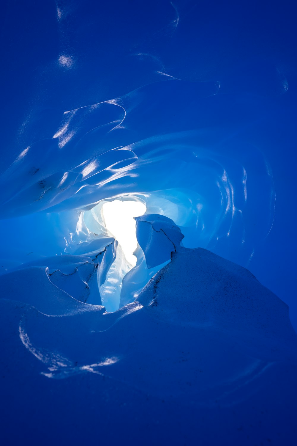 a large ice cave filled with water and snow