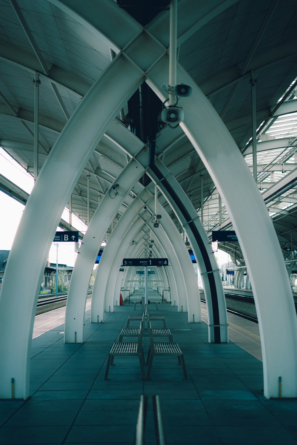 a train station with a row of benches