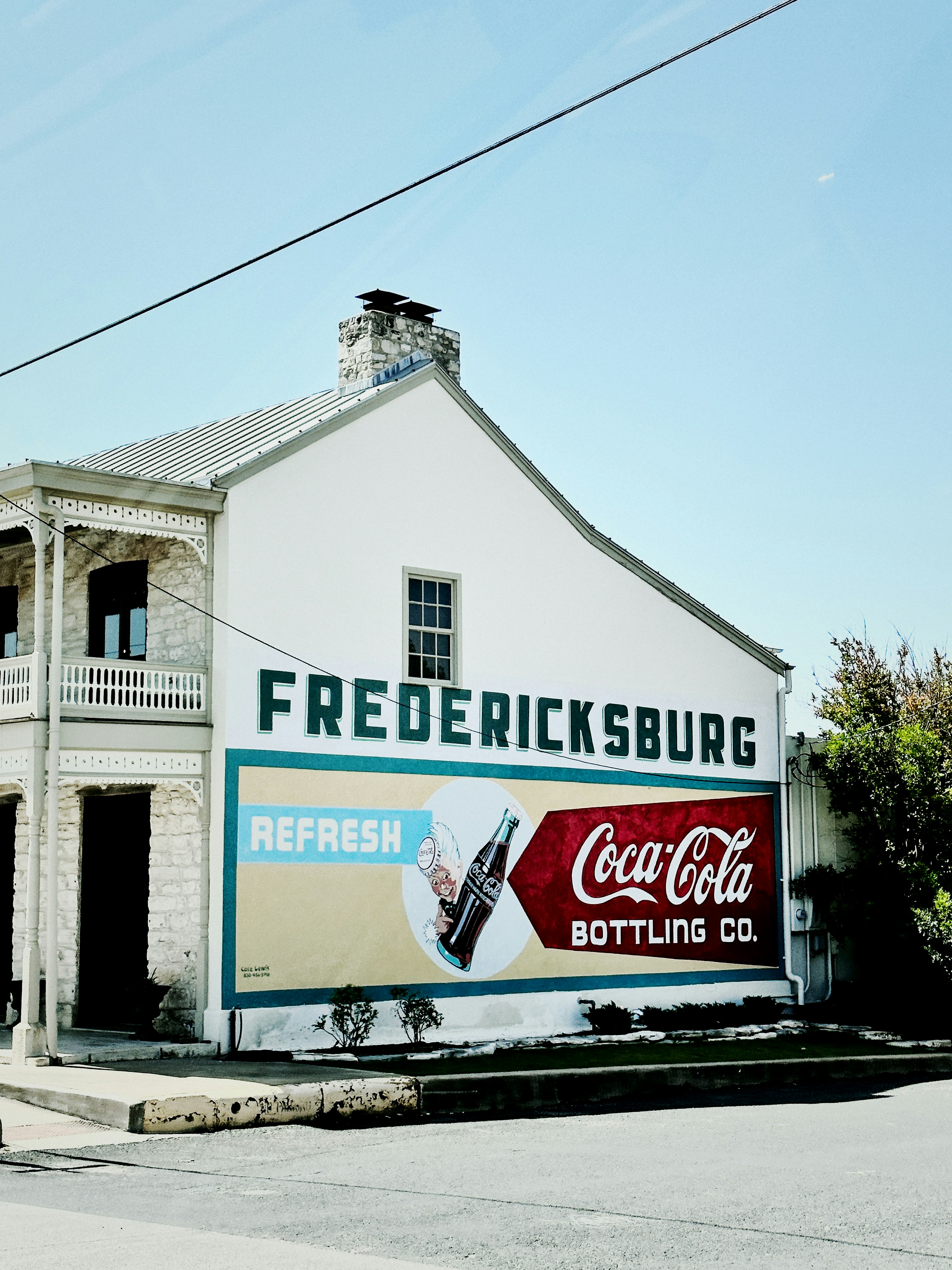 a building with a coca cola advertisement on the side of it