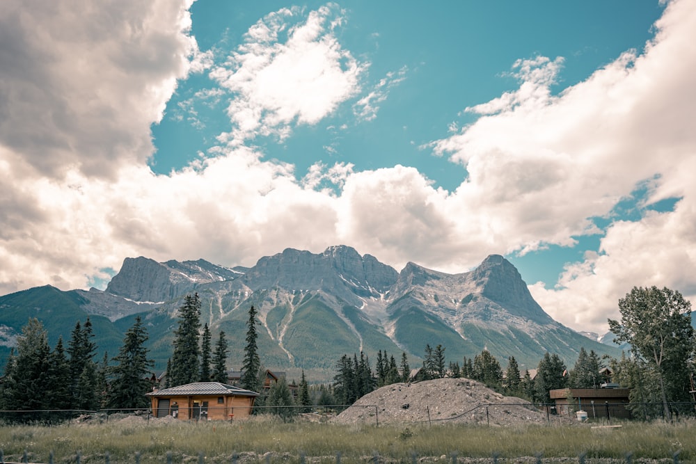 a mountain range with a house in the foreground