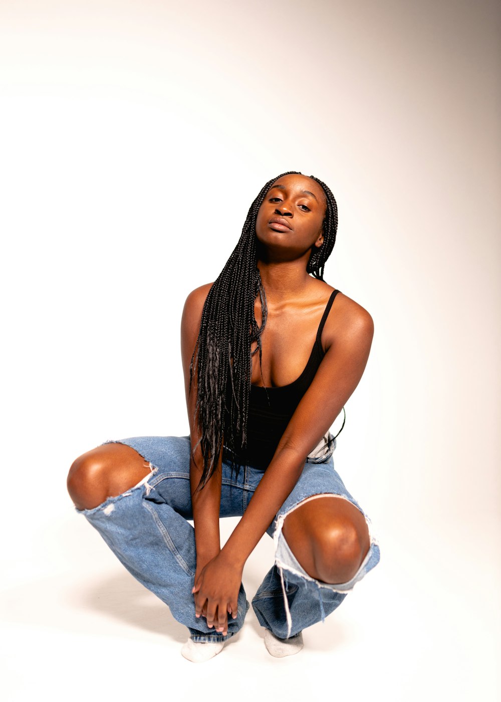 a woman sitting on the ground with her legs crossed