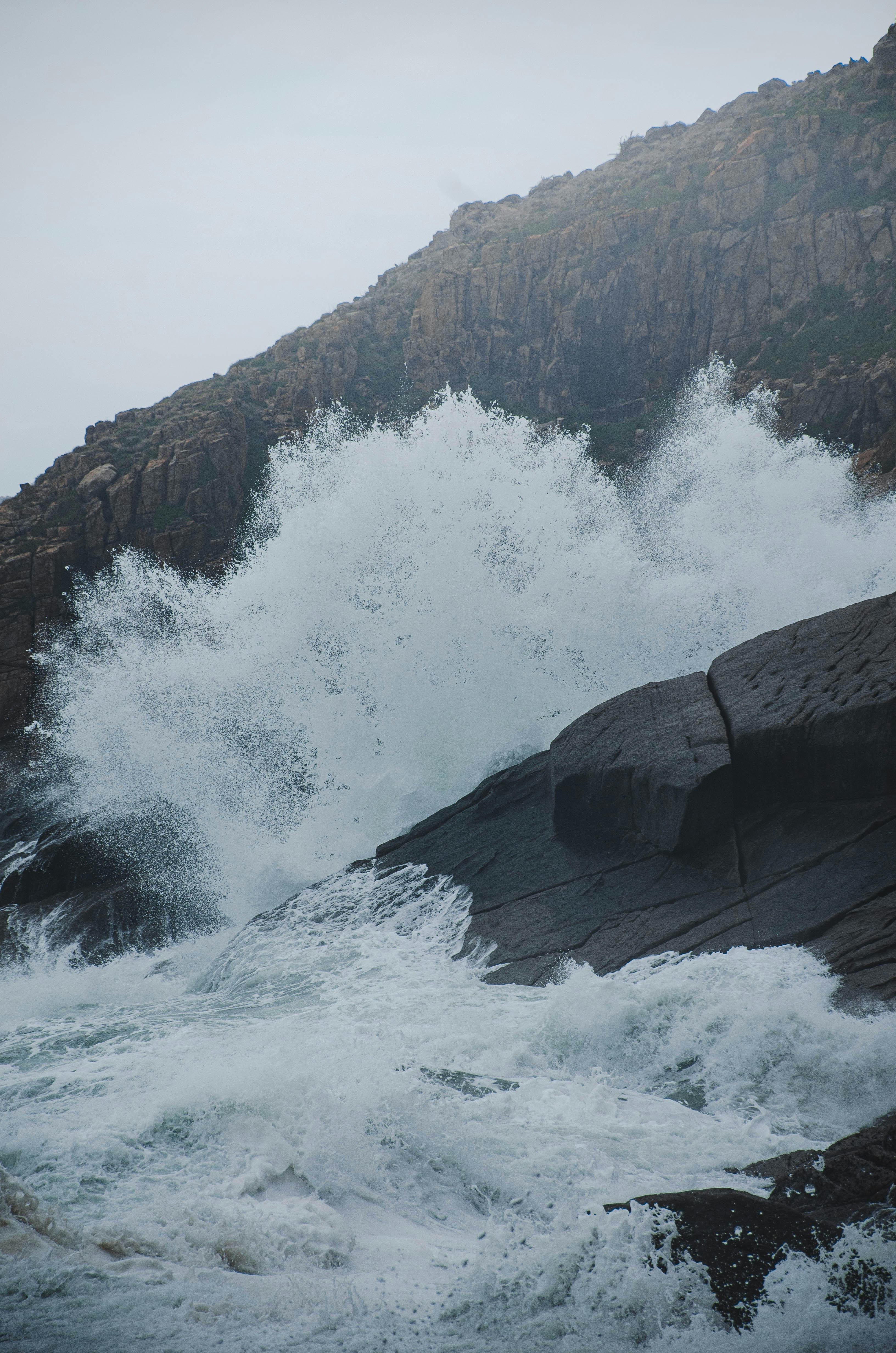 a large body of water near a rocky shore