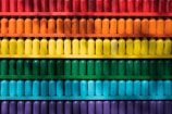 Rows of colorful reagent bottles neatly arranged on a laboratory shelf.