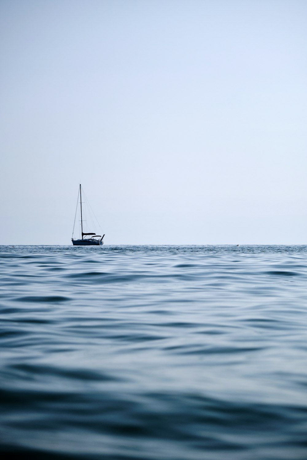 a sailboat in the middle of the ocean