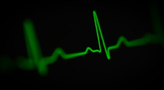 a green heart beat on a black background