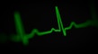 a green heart beat on a black background
