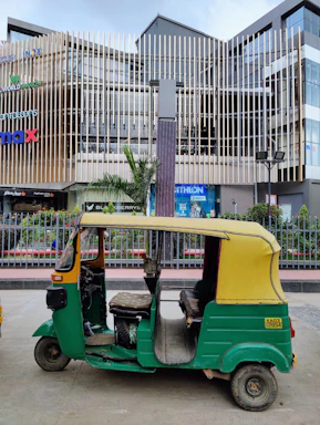 Front view of a modern electric rickshaw parked on a city street.