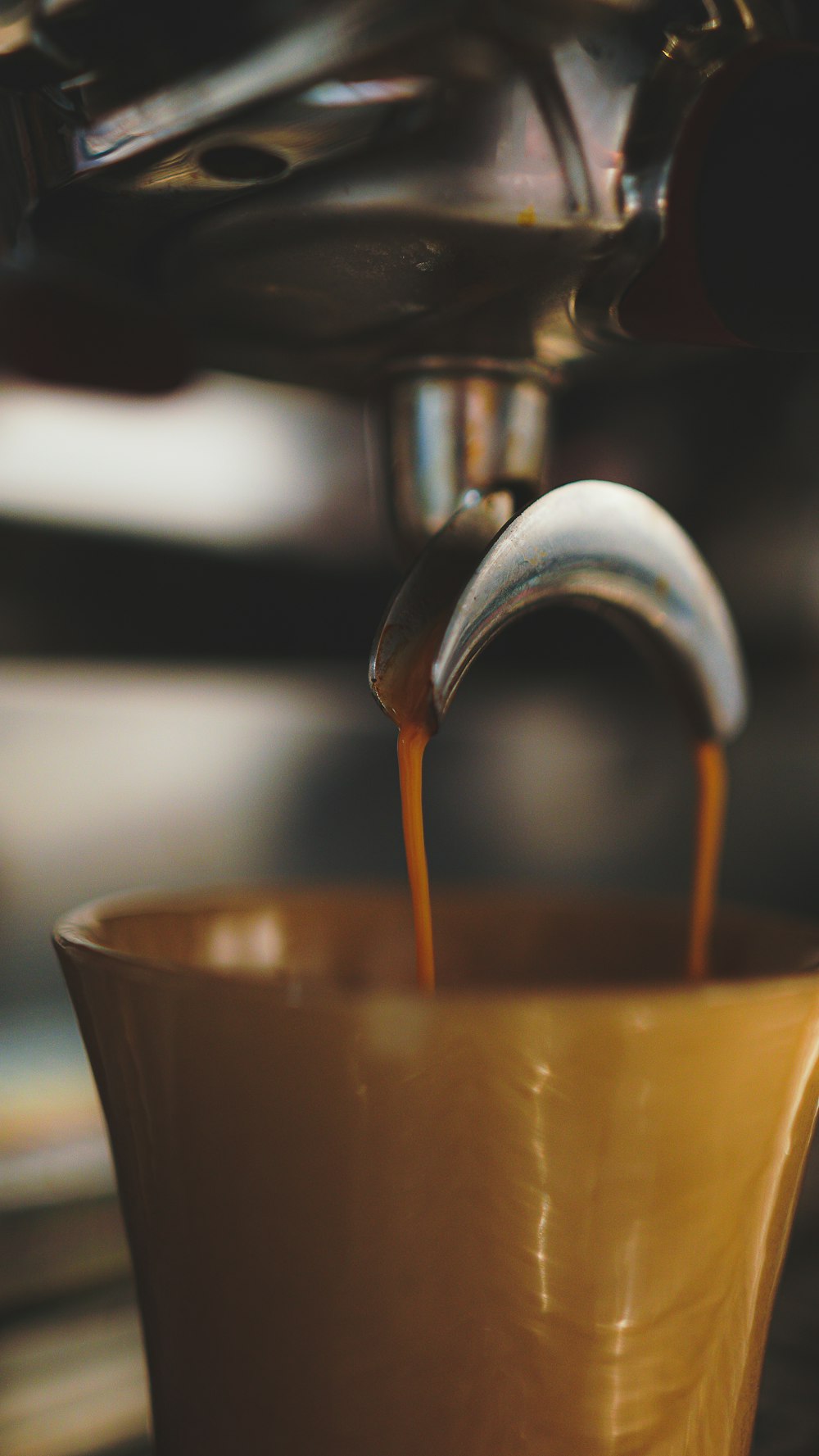 a cup of coffee being poured into it