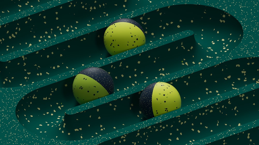 a couple of balls sitting on top of a green surface