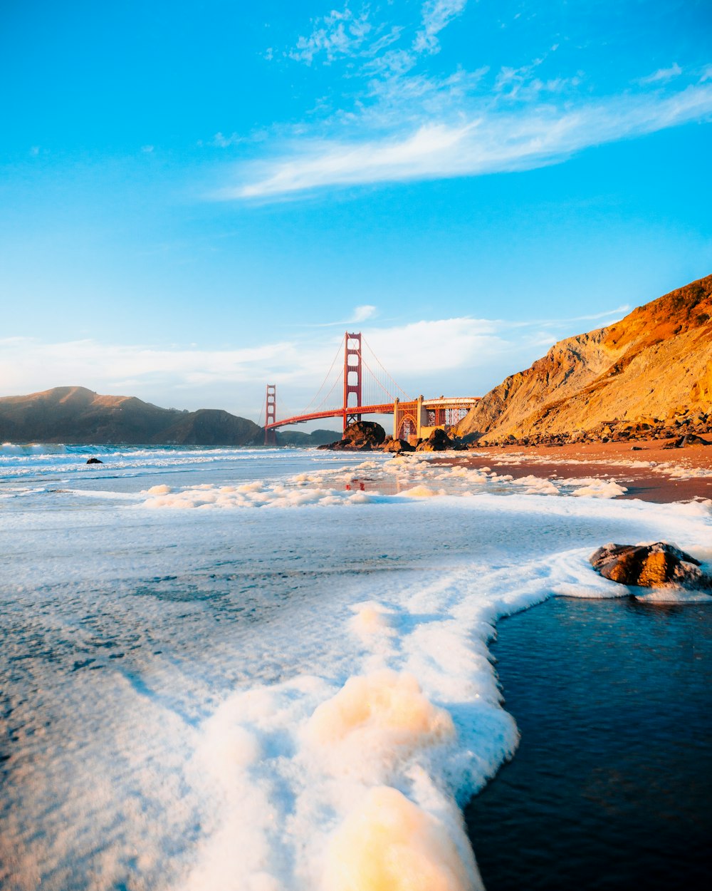 a body of water with a bridge in the background