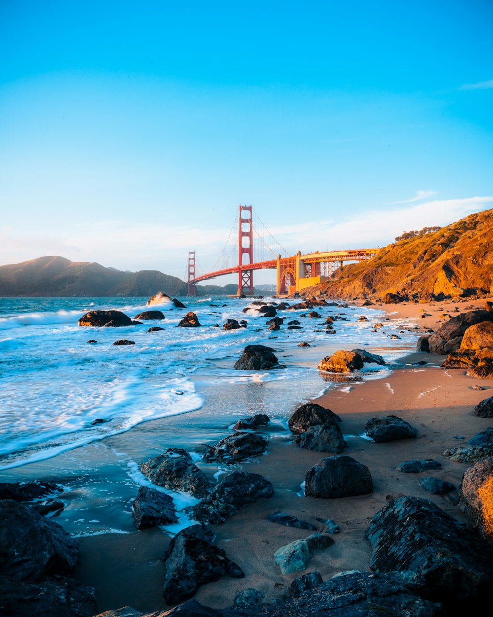 a view of the golden gate bridge from the beach