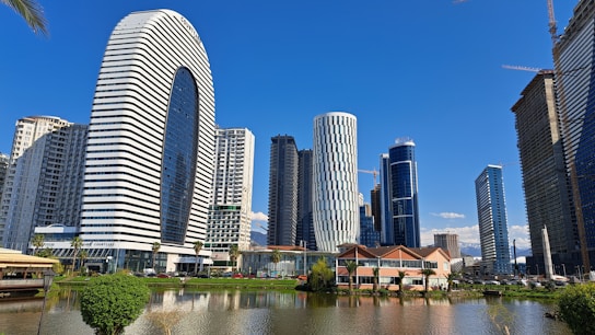 a lake in front of a city with tall buildings