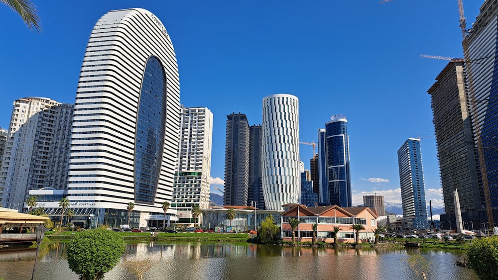 a lake in front of a city with tall buildings