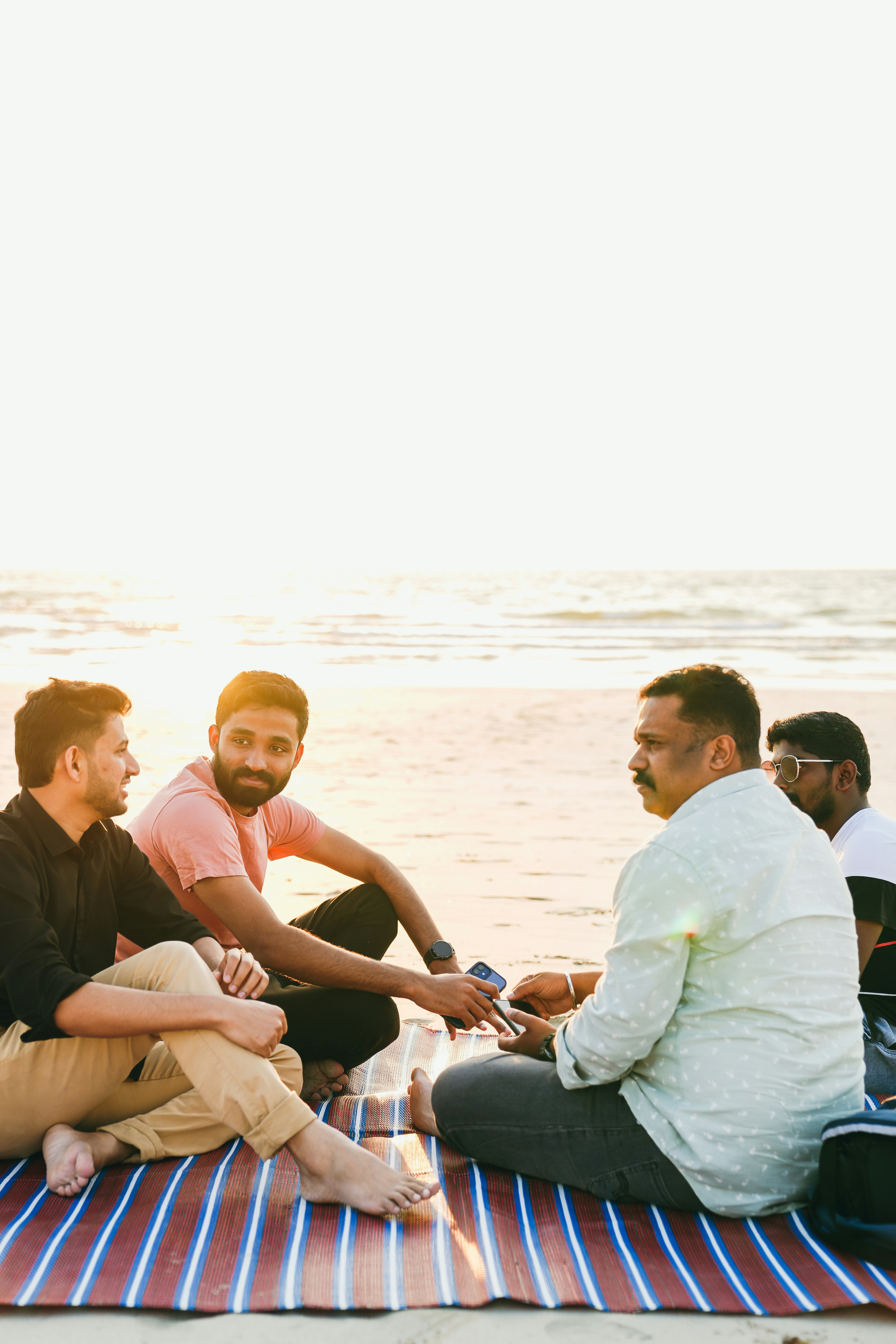 Group of friends laughing at sunset