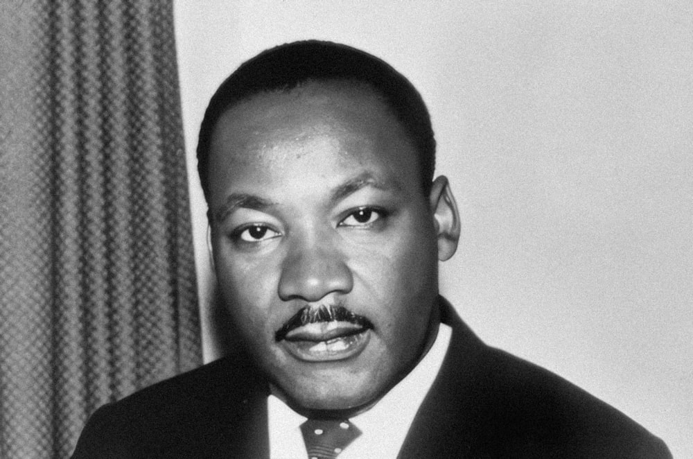 a black and white photo of a man in a suit