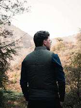 Engineer reviewing environmental documents outdoors with nature backdrop