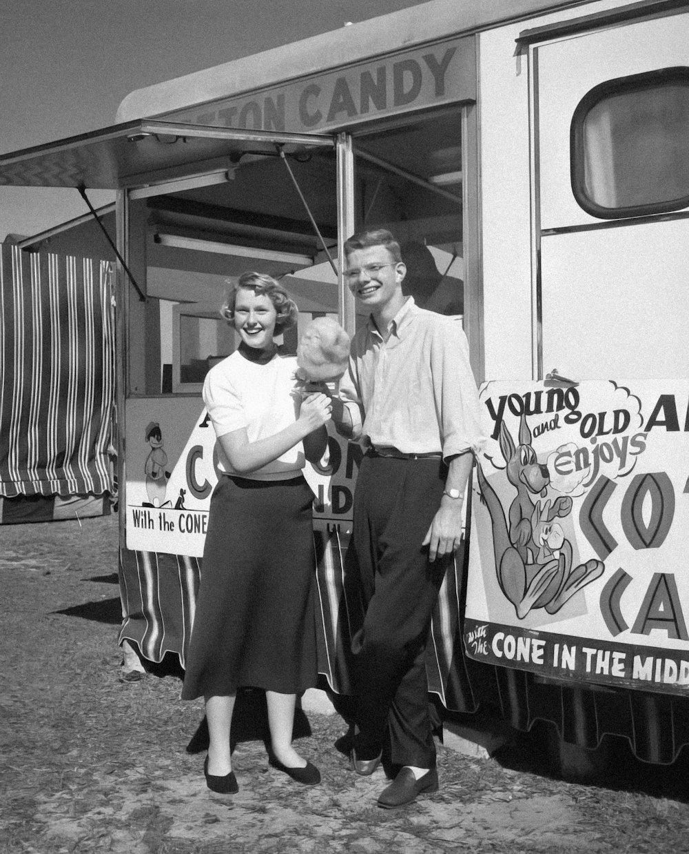 a black and white photo of a man and a woman standing in front of a