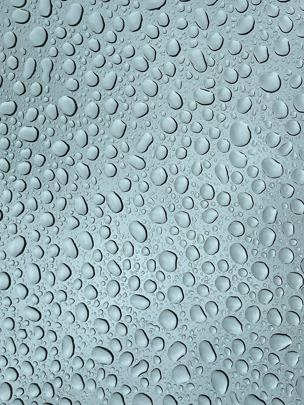 a close up of water droplets on a glass surface