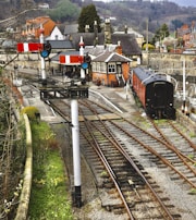 A historic train station adorned with flowers and greenery.