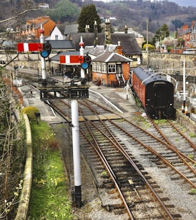 A historic train station adorned with flowers and greenery.