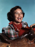 Huviky Rachel smiling while wearing a signature Rancho HR chamarrra at a rodeo event.