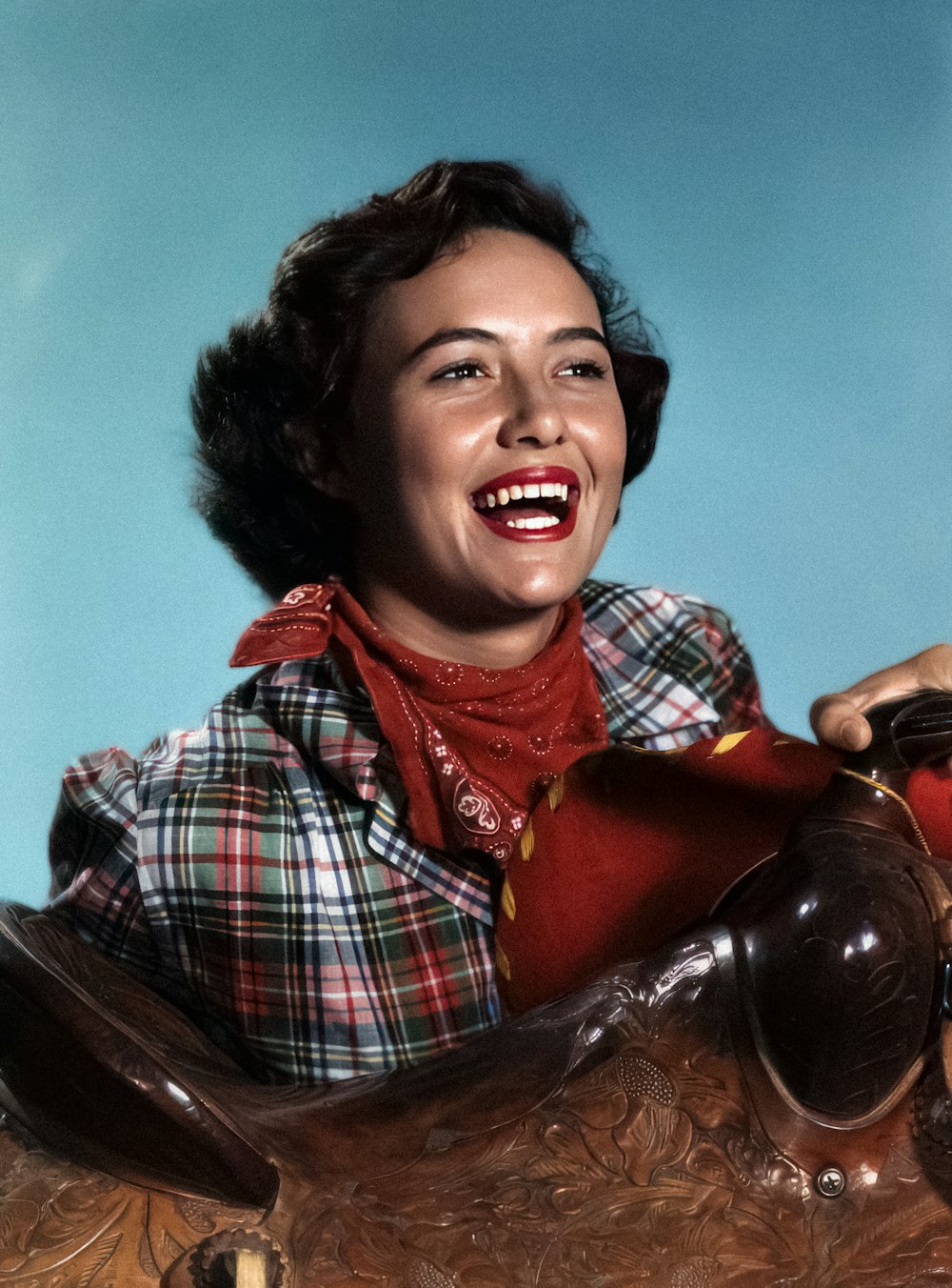 a woman sitting on top of a wooden chair