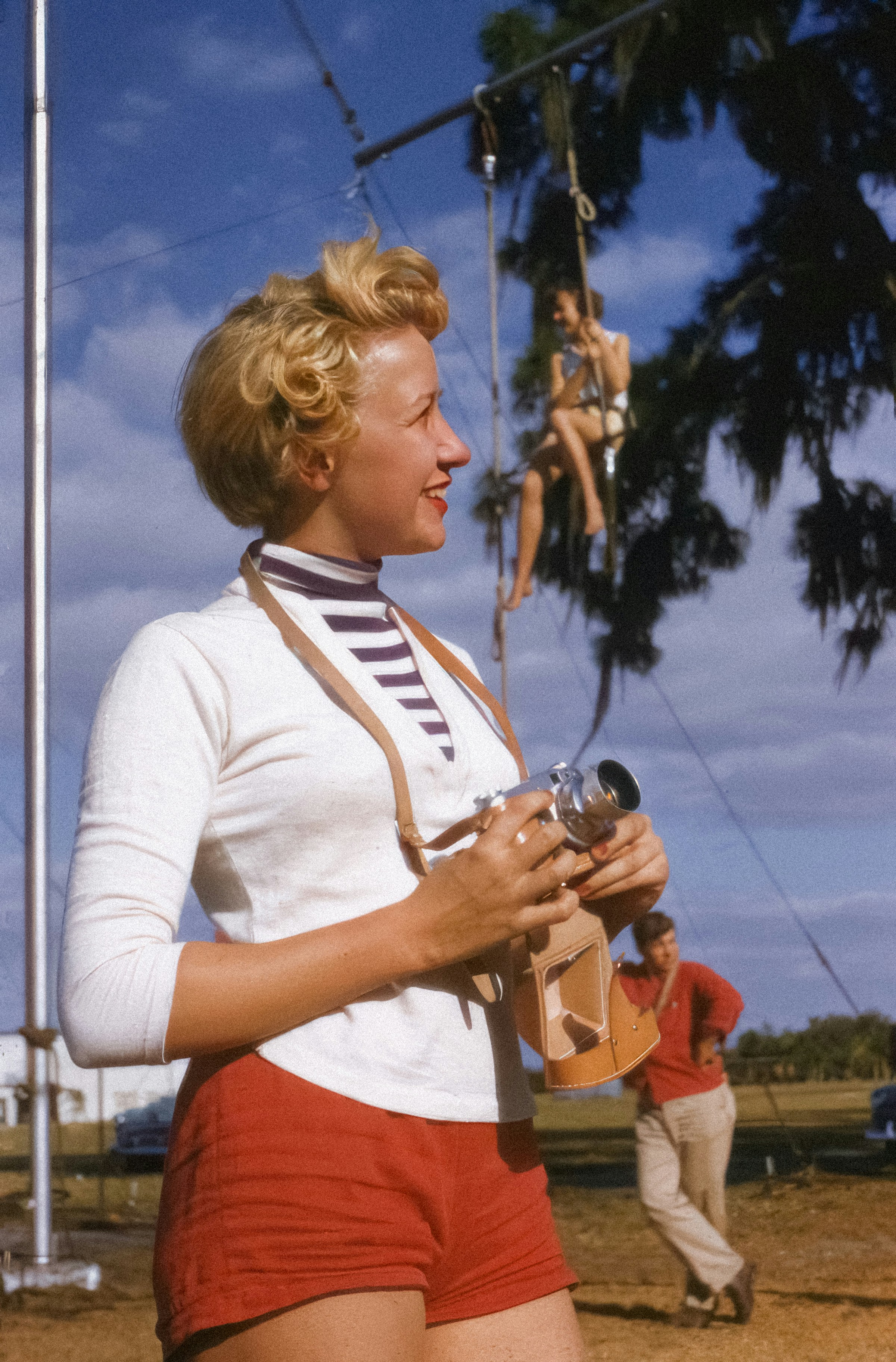 a woman in red shorts and a white shirt