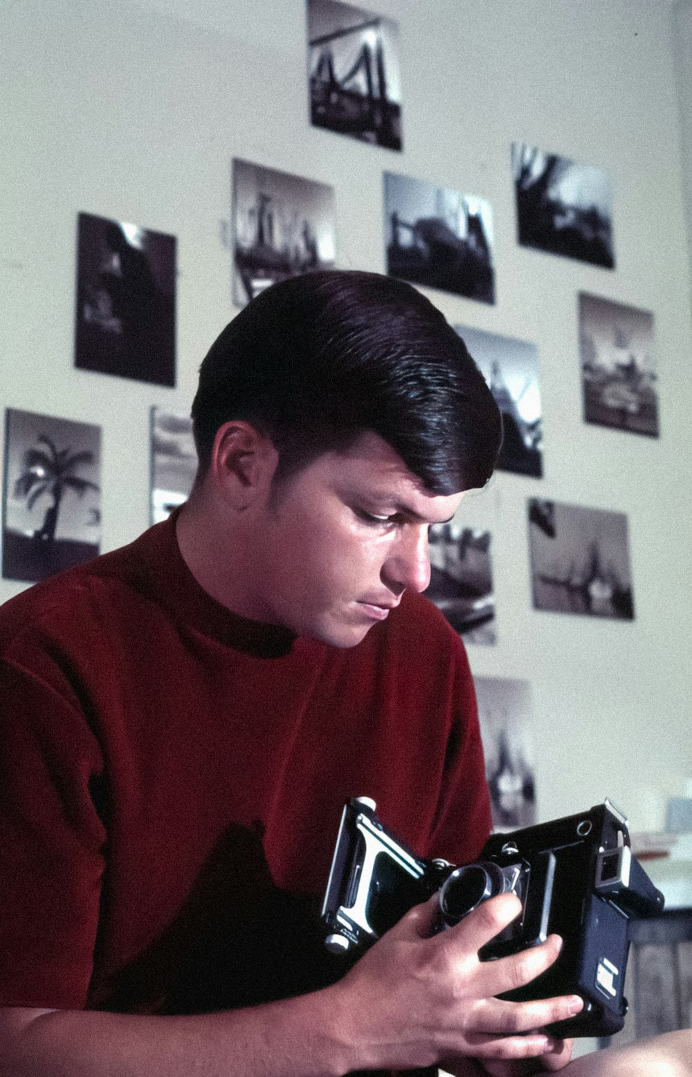 a man sitting at a table holding a camera