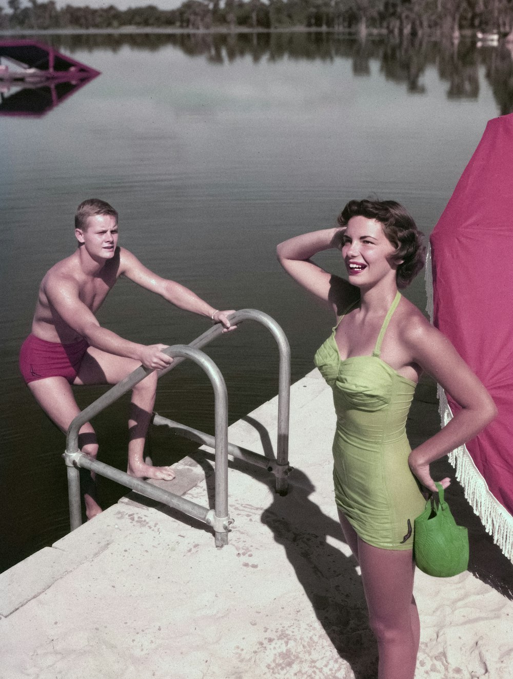 a woman in a bathing suit standing next to a man in a bathing suit