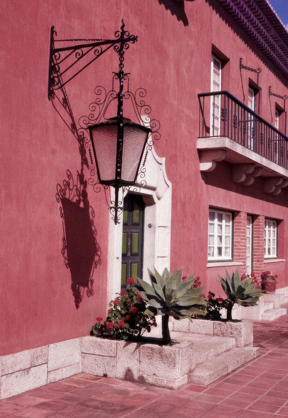 a red building with a lamp post next to it
