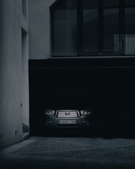 Vehicle being carefully extracted from a tight garage space.