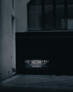 Vehicle being carefully extracted from a tight garage space.