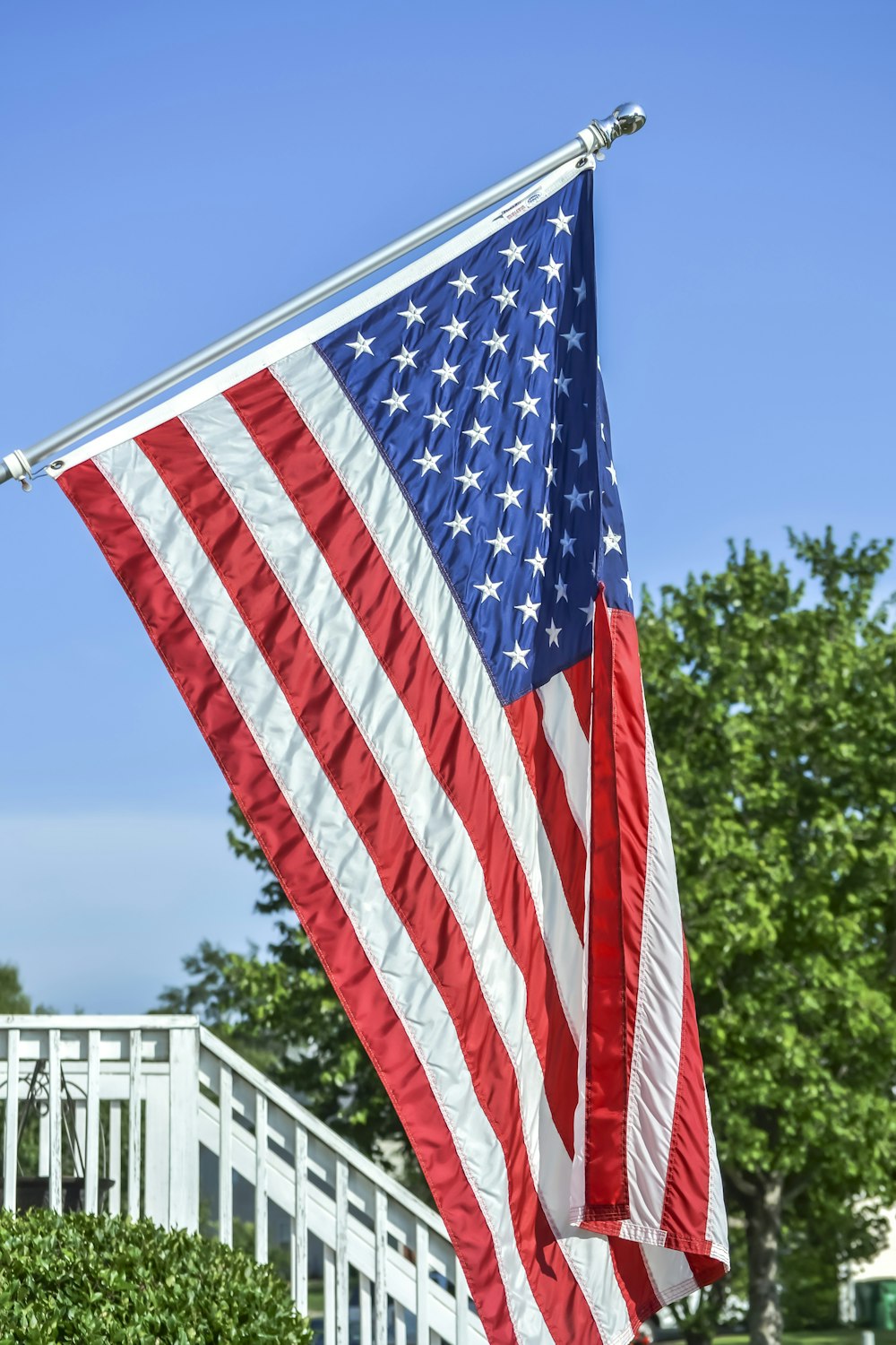 a large american flag hanging from the side of a building