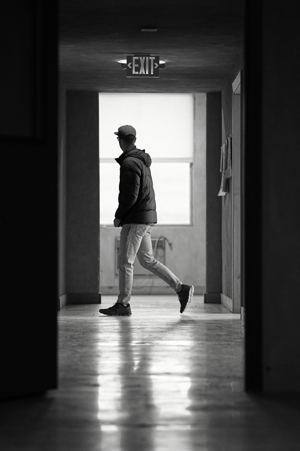 a man walking down a hallway in a building