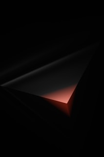 a dark room with a red light coming out of it