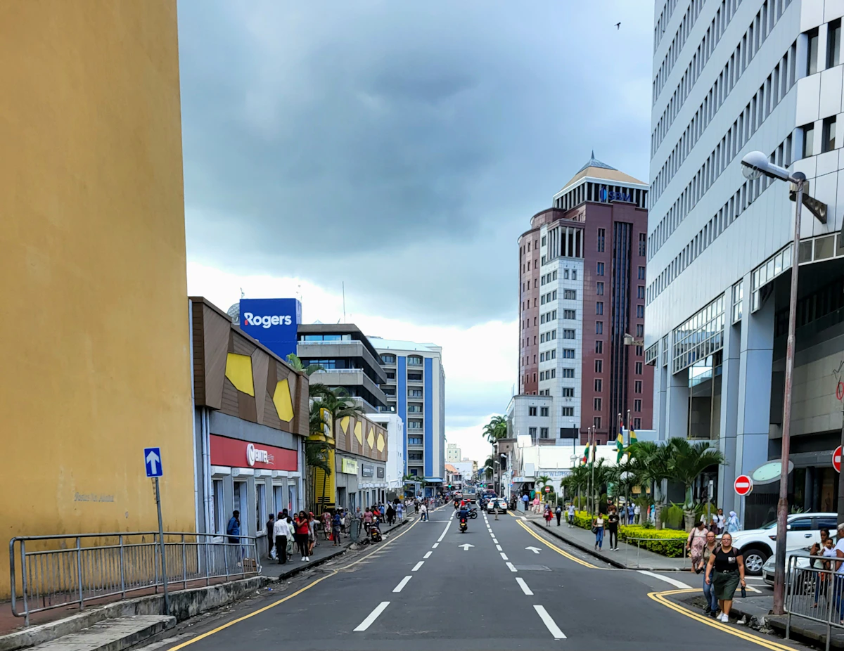 People and traffic on a central Port Louis street beneath modern office buildings
