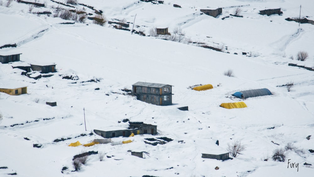 a snow covered hillside with a small building on top of it